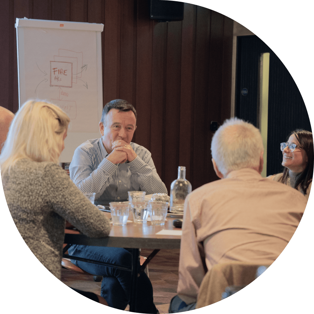 Colm Lyon and members of the Fire team seated around a table during a workshop.