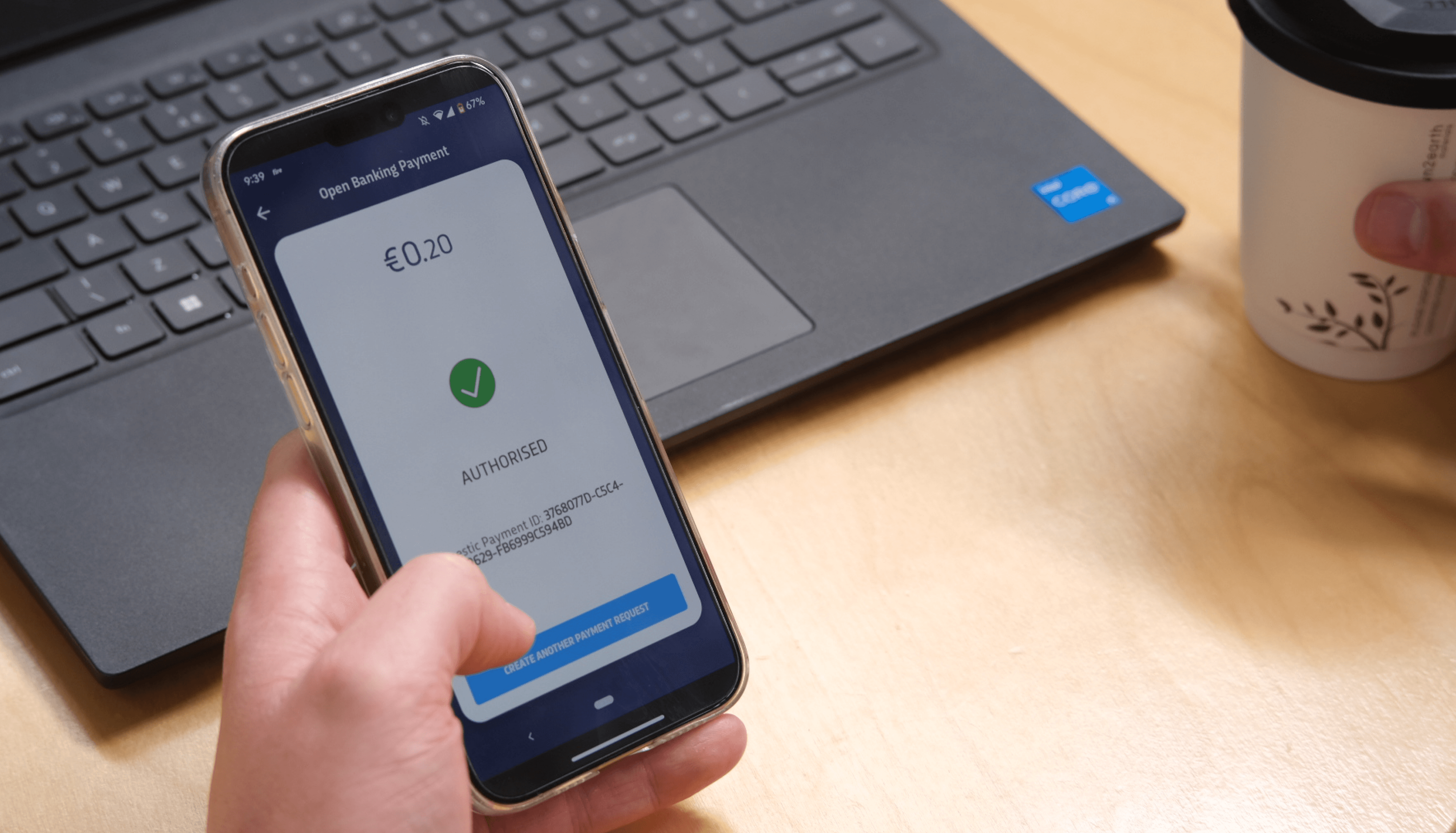 Hand holding a mobile phone, showing an authorised open banking payment.