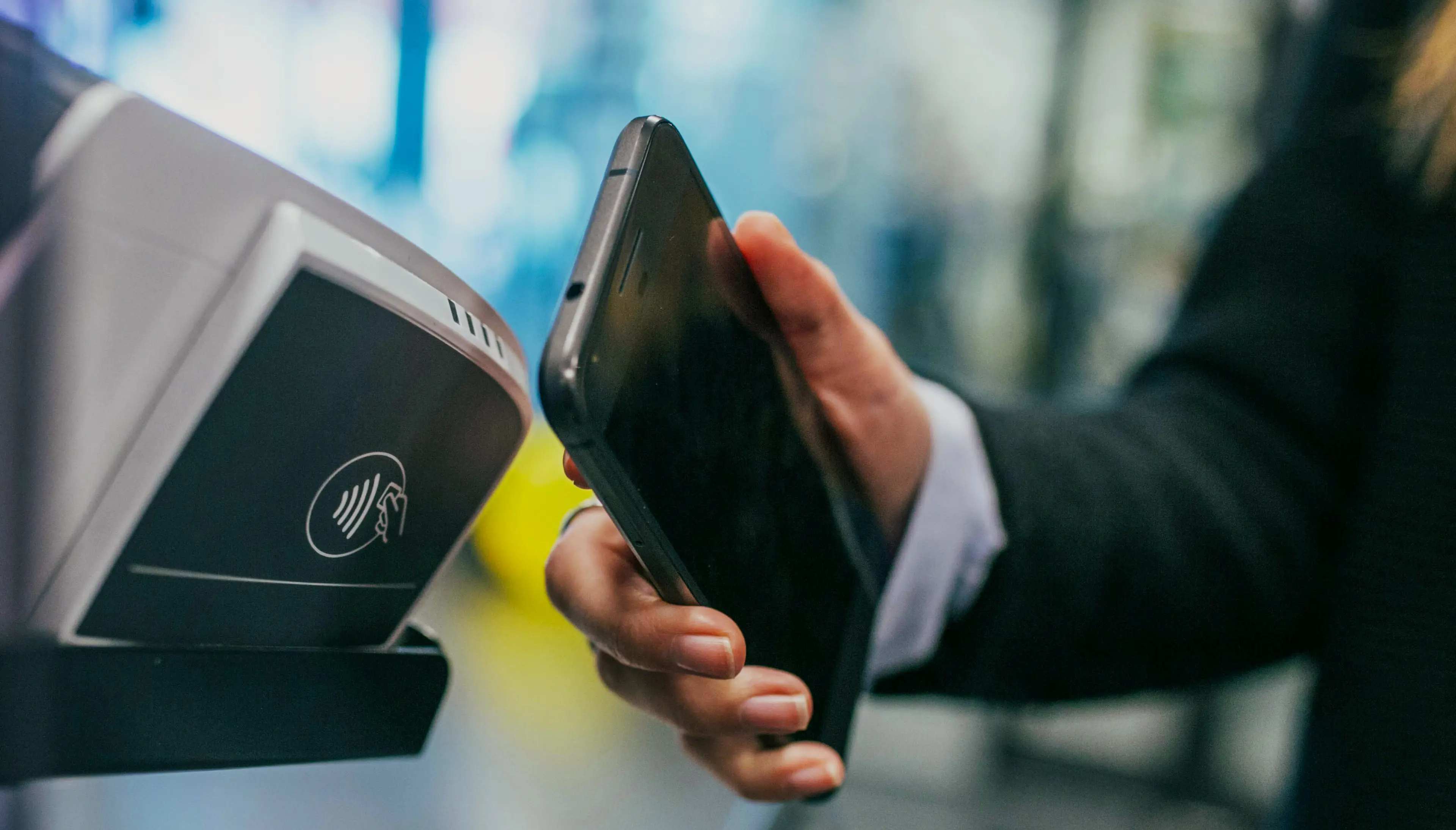 Mobile phone used for a digital payment at a contactless reader.